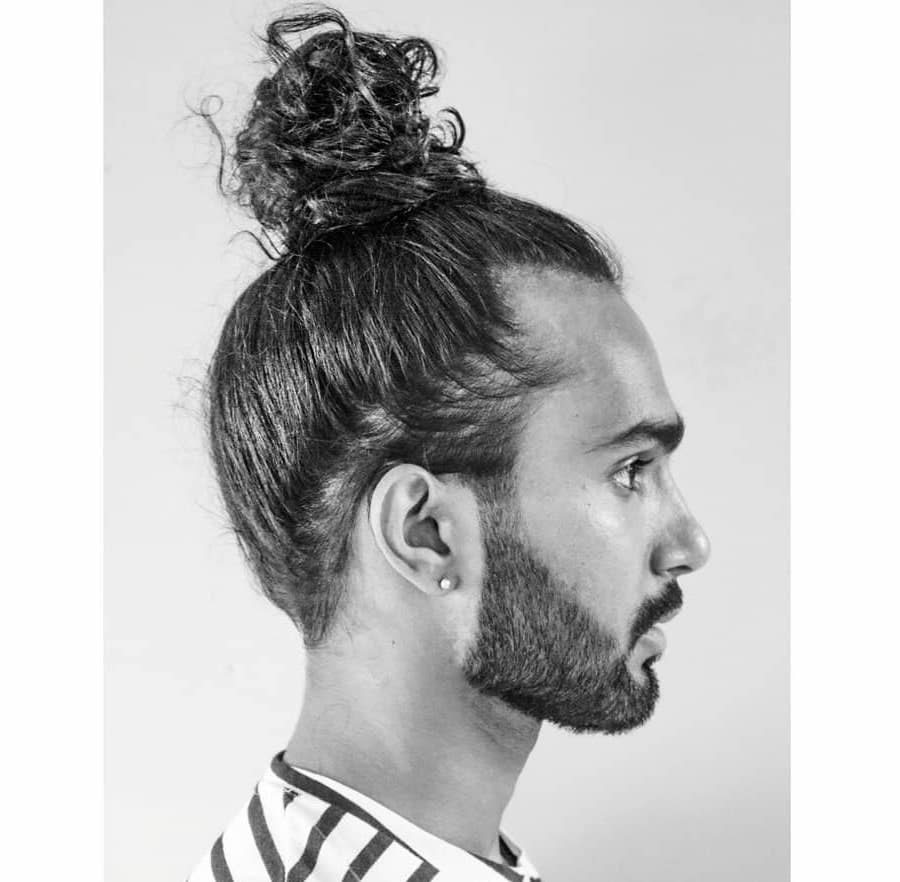 Man bun hairstyle for long curly hair men