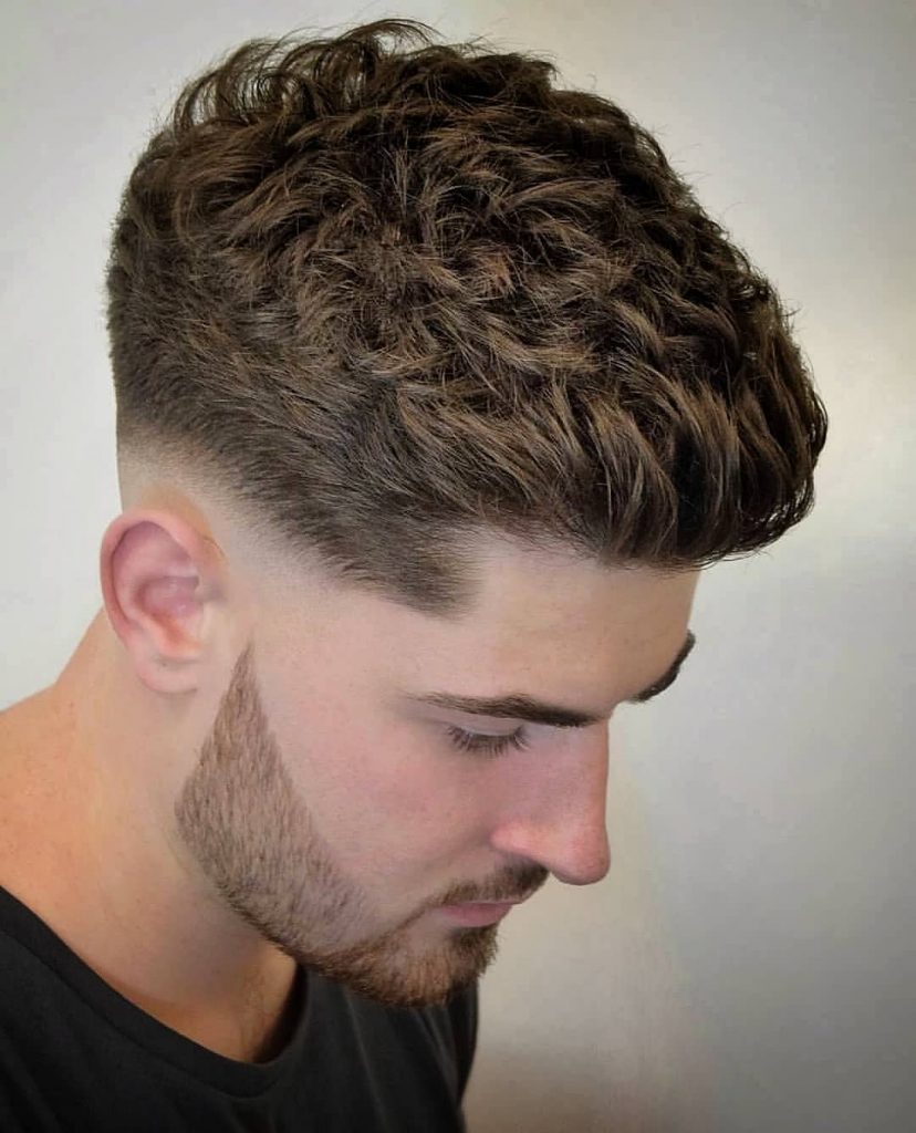 Low bald fade haircut for wavy hair men