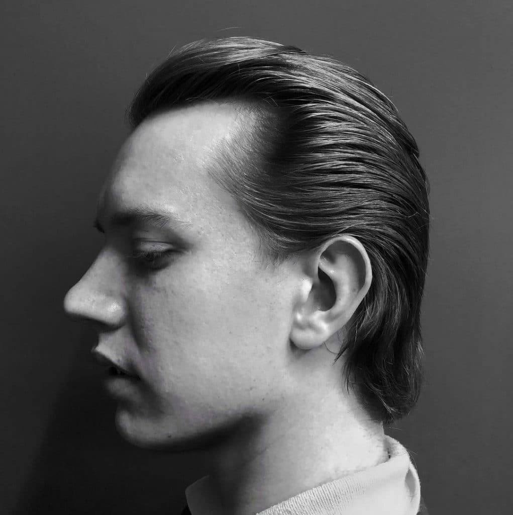 Men's medium haircut slicked back