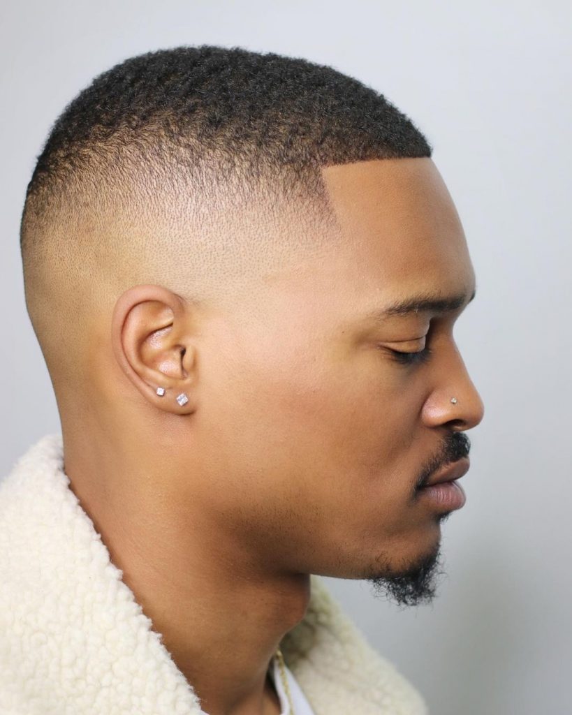 Men's high  fade haircut with waves