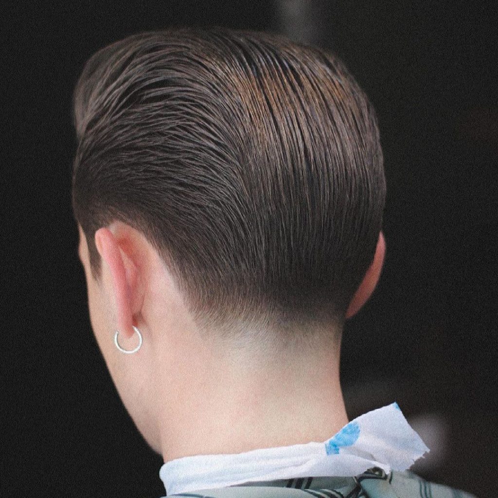 Slicked back taper fade haircut