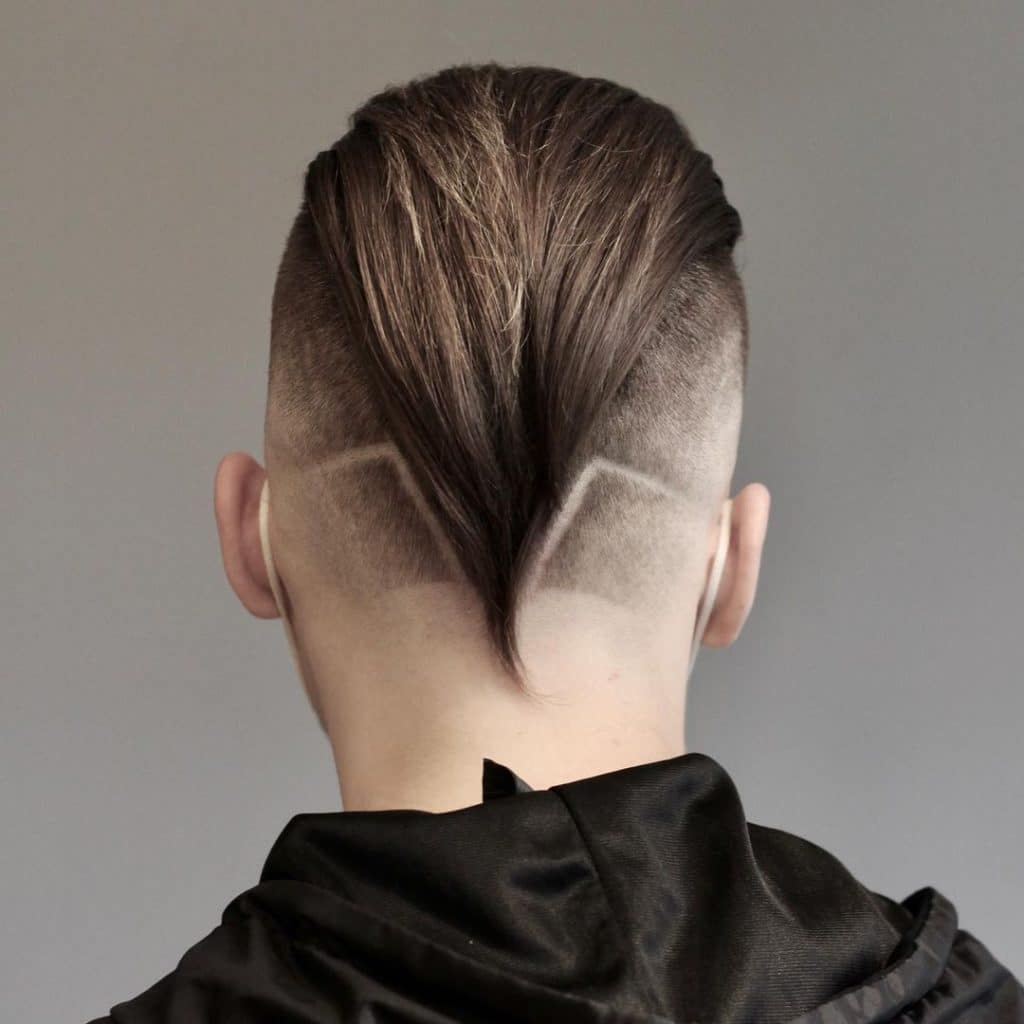 Slicked back undercut fade with designs