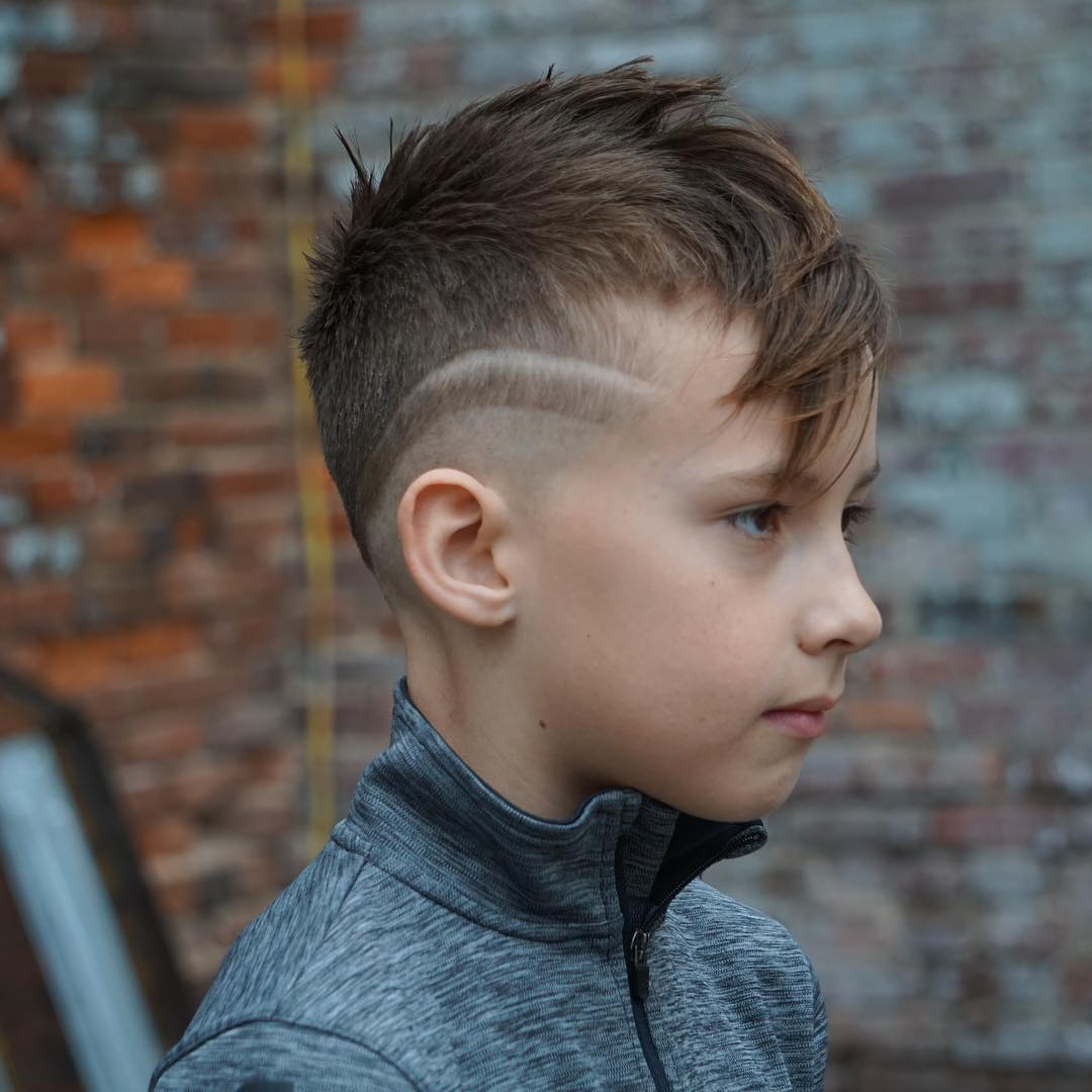 Mohawk haircut with long fringe and mid fade with hair design